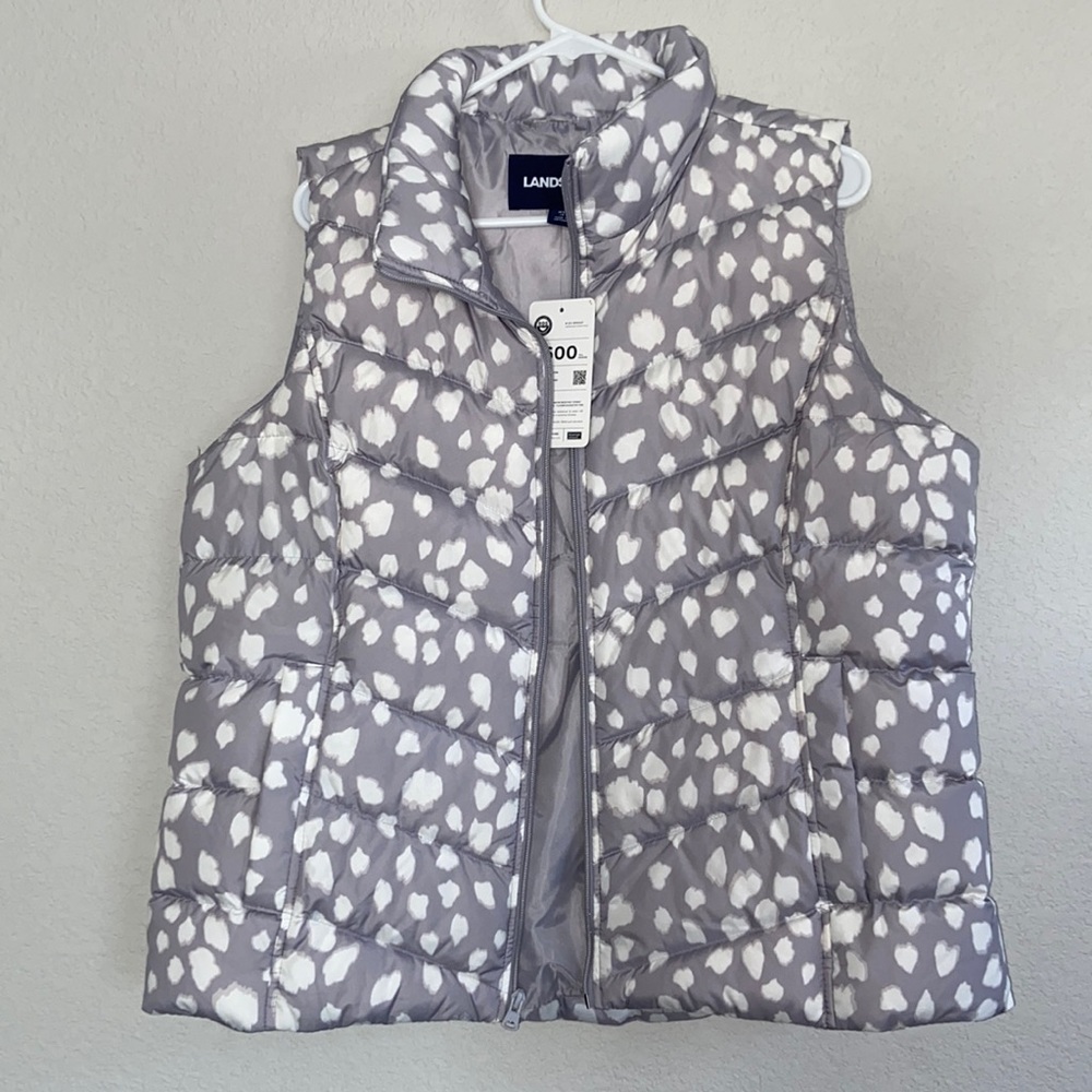Vest is gray with white spots.